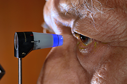 Older man receiving an eye exam from an Eye Doctor